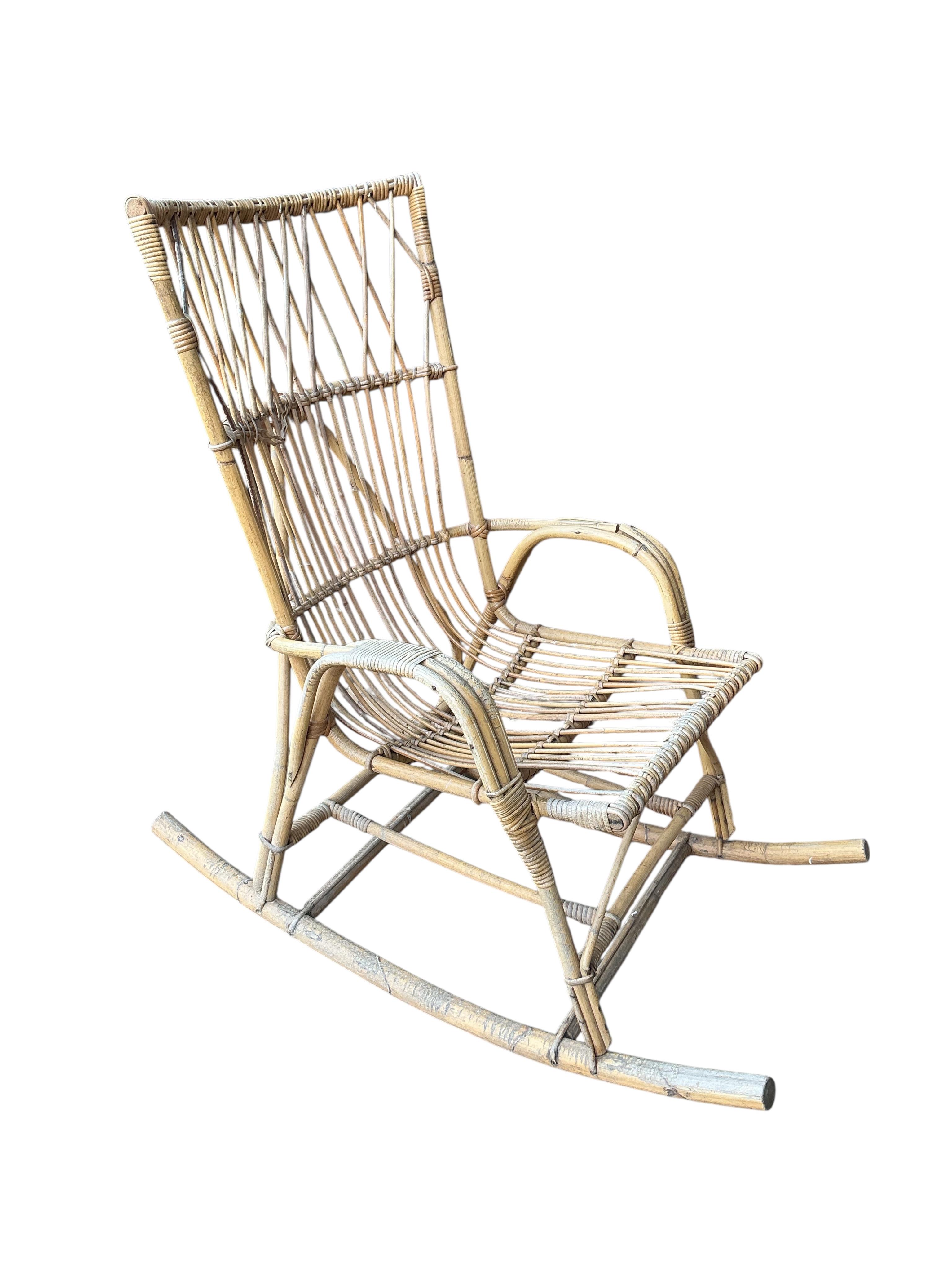 A vintage caned bamboo rocking chair, width 62cm, depth 101cm, height 106cm